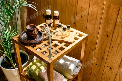 Preview: Dropper bottle with natural essential lavender oil and purple lavender flowers on wooden bamboo tabl