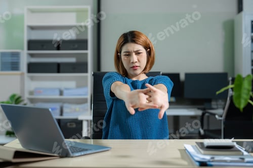 Preview: Businesswoman is doing a stretchy posture due to sitting in the office for too long, office syndrome