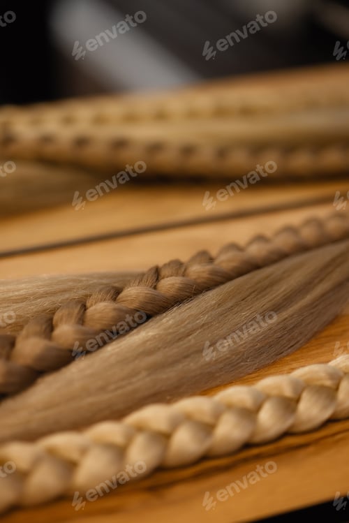 Preview: Blonde braid extensions on wooden table with metal rings