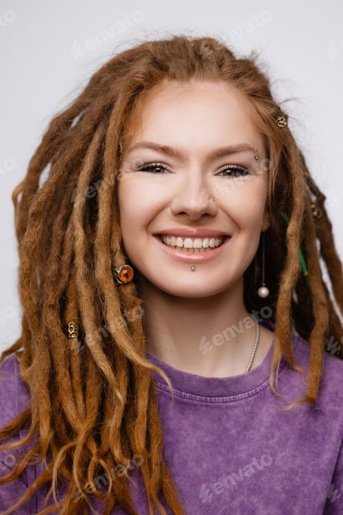 Preview: Smiling Caucasian woman with dreadlocks and piercing isolated on white background