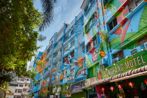 Preview: Kuala Lumplur, Malaysia streets. An apartment building decorated with vibrant blue paintings