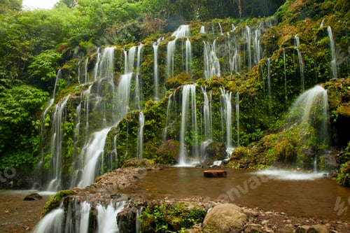 Preview: Multi-stream tropical waterfall in Bali. Banyu Wana Amertha waterfall overgrown with lush greenery