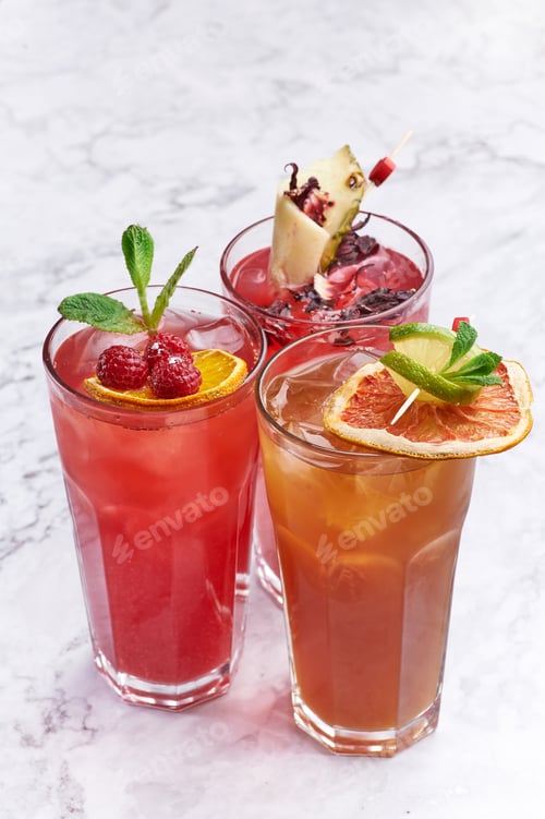 Preview: Summer fresh cocktails concept. orange and red alcohol drinks close up. Copy space.