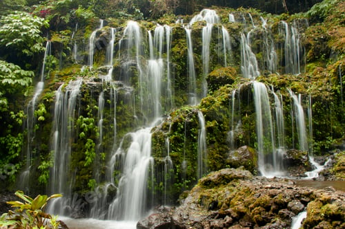 Preview: A tropical Banyu Wana Amertha waterfall in Bali with many streams overgrown with lush greenery
