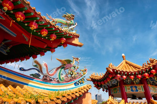 Preview: A colorful Chinese Temple top decorated with lanterns and a dragon with a blue sky behind