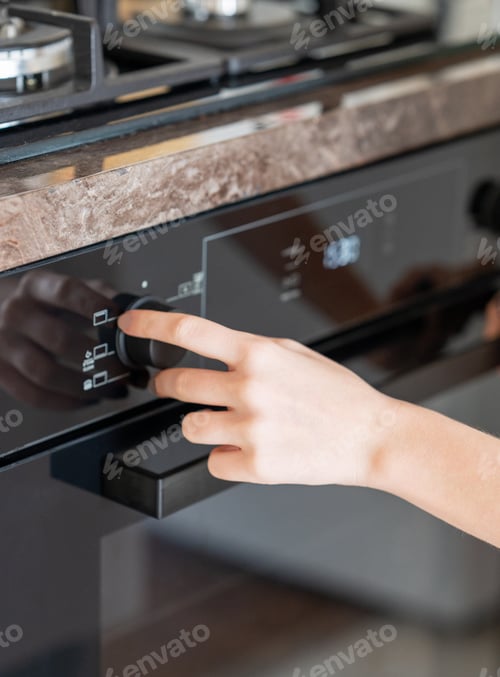 Preview: Hand Turning Oven Control in Modern Kitchen
