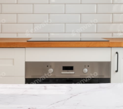 Preview: Modern marble kitchen countertop with oven, cooktop and white tiles in the background