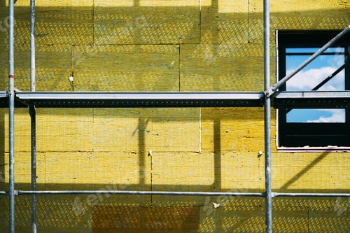 Preview: Mineral wool house insulation. Construction site with scaffolding and high-density slab insulation p