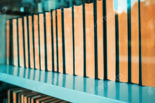 Preview: Hardcover books on the shelf in public library seen through the glass window