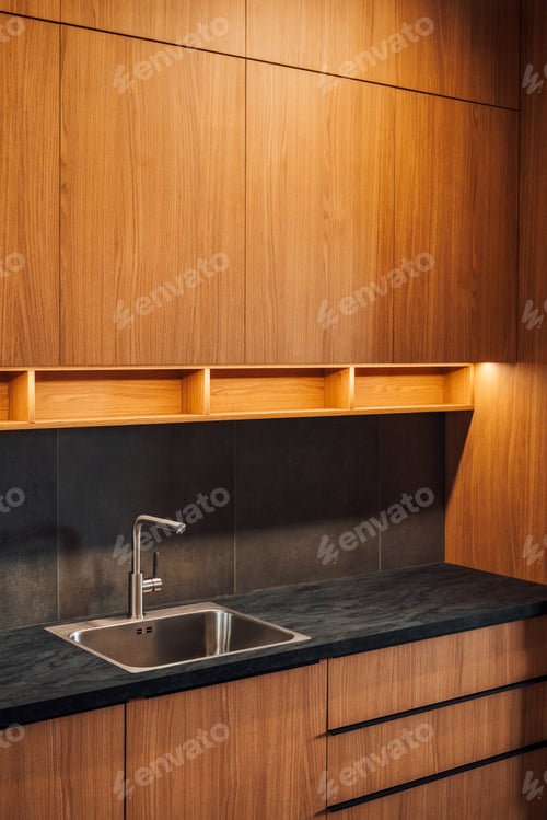 Preview: Water faucet and metallic sink in modern sleek kitchen with led strip light