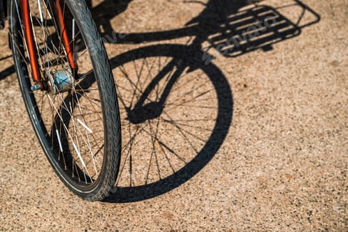 Preview: Bicycle wheels and frames casting graphic shadows on ground, cycling and sustainable transport theme