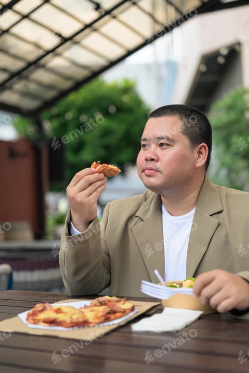 Preview: Pensive plus size Isan Thai businessman with pizza slice vertical