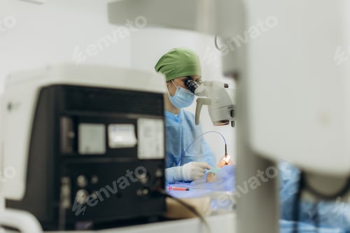 Preview: Surgeon performing eye surgery with microscope in operating room