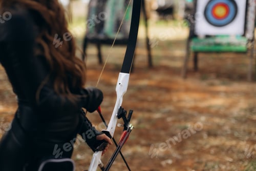 Preview: Archer holding bow aiming at target for precision sport