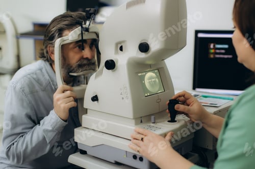 Preview: Man receiving eye exam with optometrist performing vision test
