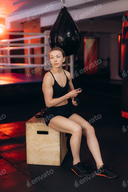 Preview: Woman athlete preparing for boxing workout in gym