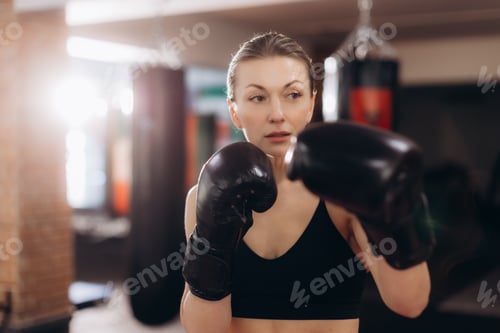 Preview: Woman boxing training with gloves in gym