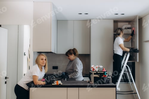 Preview: Cleaning service professionals working in modern kitchen