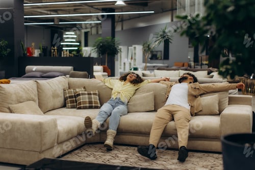 Preview: Happy couple relaxing on new comfortable sofa