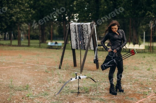 Preview: Woman preparing to shoot with bow and arrows