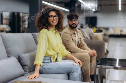 Preview: Couple choosing buying sofa in furniture store showroom