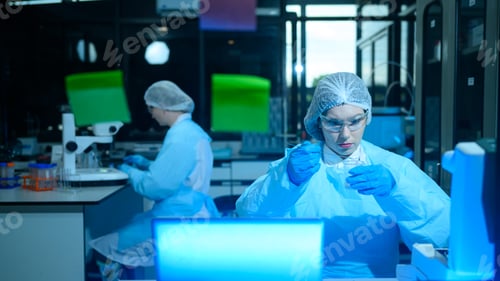 Preview: Female Scientists Working in Modern Research Laboratory with Safety Equipment and Computer Screens