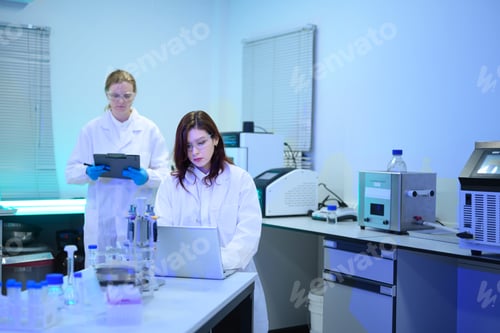 Preview: Two Female Scientists Working in Modern Research Laboratory with Equipment and Laptop