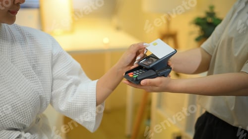 Preview: Closeup woman paying with card at spa using terminal , Wellness business concept