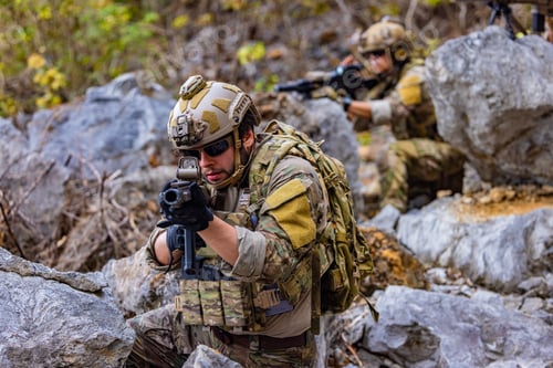 Preview: Armed soldier aiming rifle during tactical exercise
