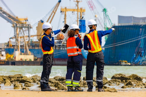 Preview: Engineers Reviewing Plans at Busy Shipping Port