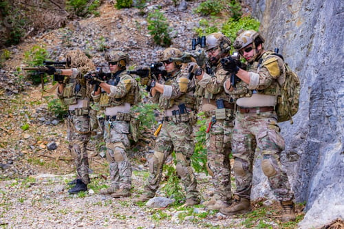 Preview: Armed soldier aiming rifle during tactical exercise