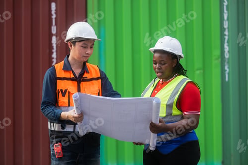Preview: Logistics team assessing stacked shipping containers