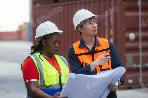 Preview: Logistics team assessing stacked shipping containers