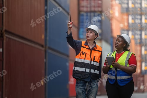 Preview: Logistics team assessing stacked shipping containers