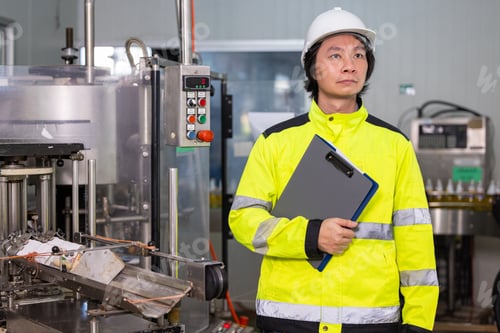 Preview: Factory Worker Inspecting Bottled Beverage Quality