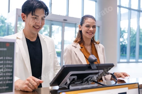 Preview: Business professionals checking in at reception kiosk