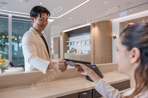 Preview: Receptionist assisting guest at office front desk