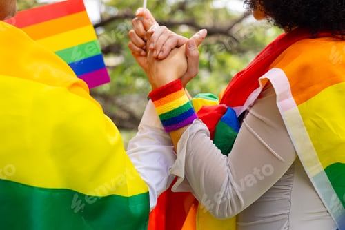 Preview: Couple holding hands with rainbow ribbons