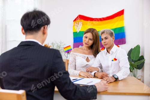 Preview: Couple signing wedding papers with Pride flag