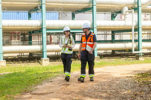 Preview: Engineers Discussing Operations at Oil Refinery Pipeline System