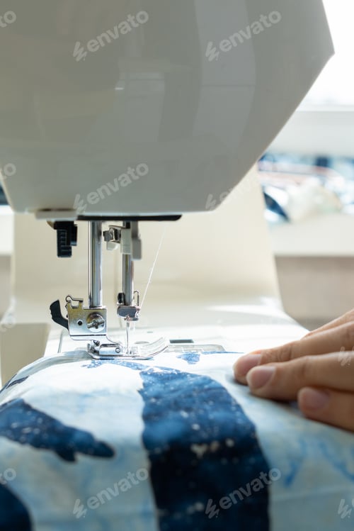 Preview: Person Sews Product Made Blue Fabric on Sewing Machine. Tailor Focused on Work, Calm Relaxed Mood.