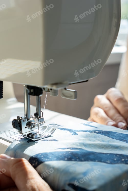 Preview: Person Sews Product Made Blue Fabric on Sewing Machine. Tailor Focused on Work, Calm Relaxed Mood.