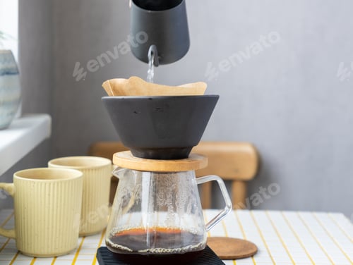 Preview: Coffee Made From Coffee Beans. Person Makes Coffee Through a Paper Filter, Pour Over or Drip.