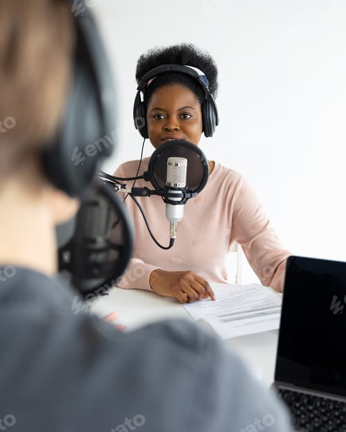 Preview: Podcasters, African American and European woman with headphones and microphone