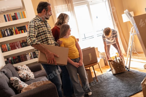 Preview: A family is moving into a new apartment, unpacking boxes together in the living room.