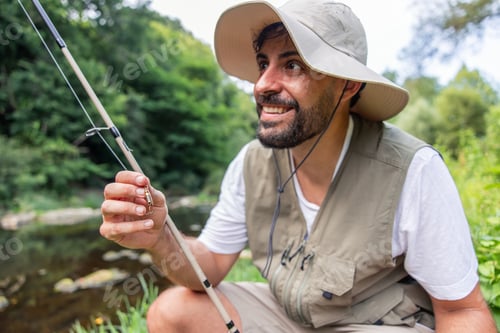 Preview: Hispanic fisherman smiling enjoying fishing day in river
