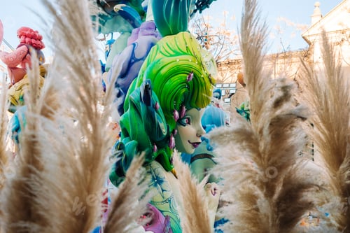 Preview: Colorful ninot in valencia with decorative plants nearby