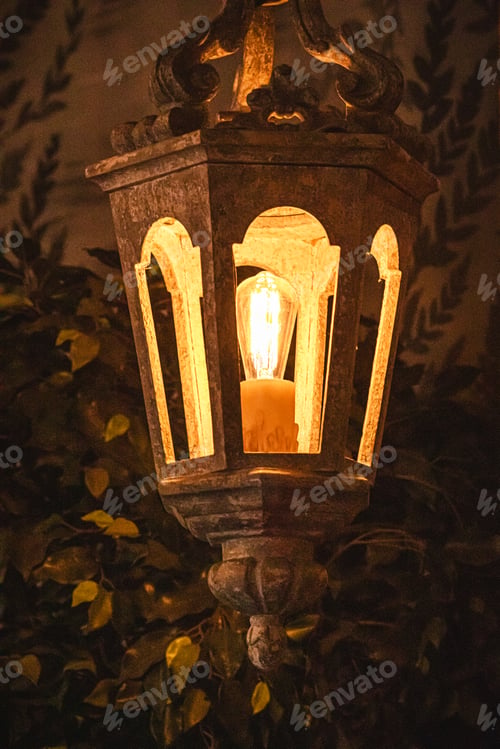 Preview: Vintage lantern with warm glowing light at night
