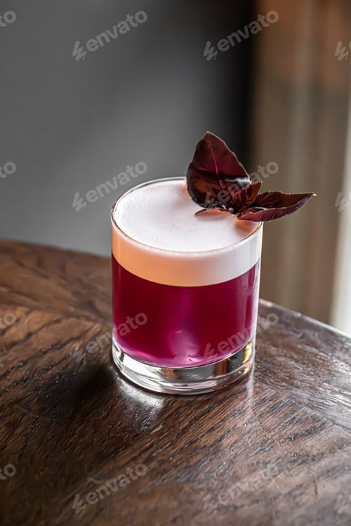 Preview: Red cocktail with foam and basil garnish
