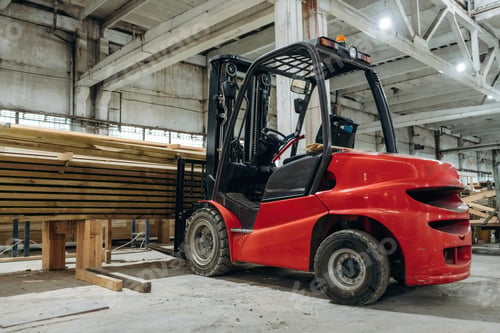 Preview: Red forklift inside a warehouse used for handling wooden material